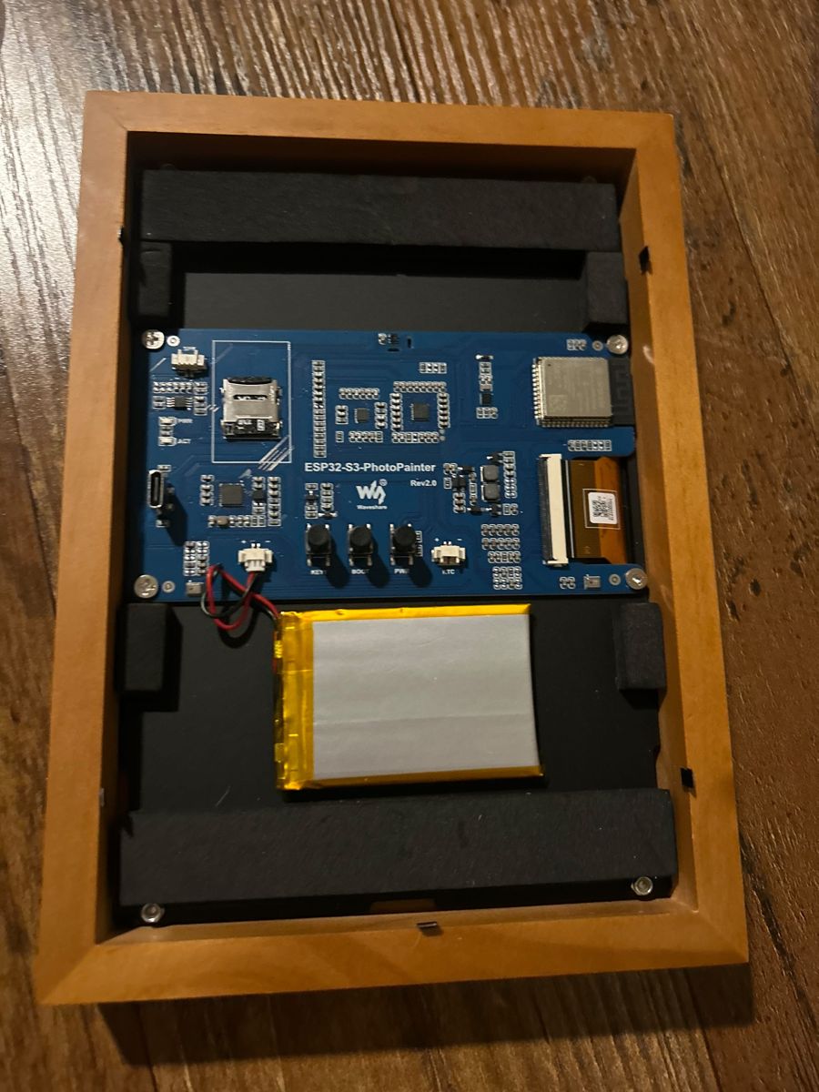 the inside of the frame: esp32-s3 board, e-paper ribbon, battery